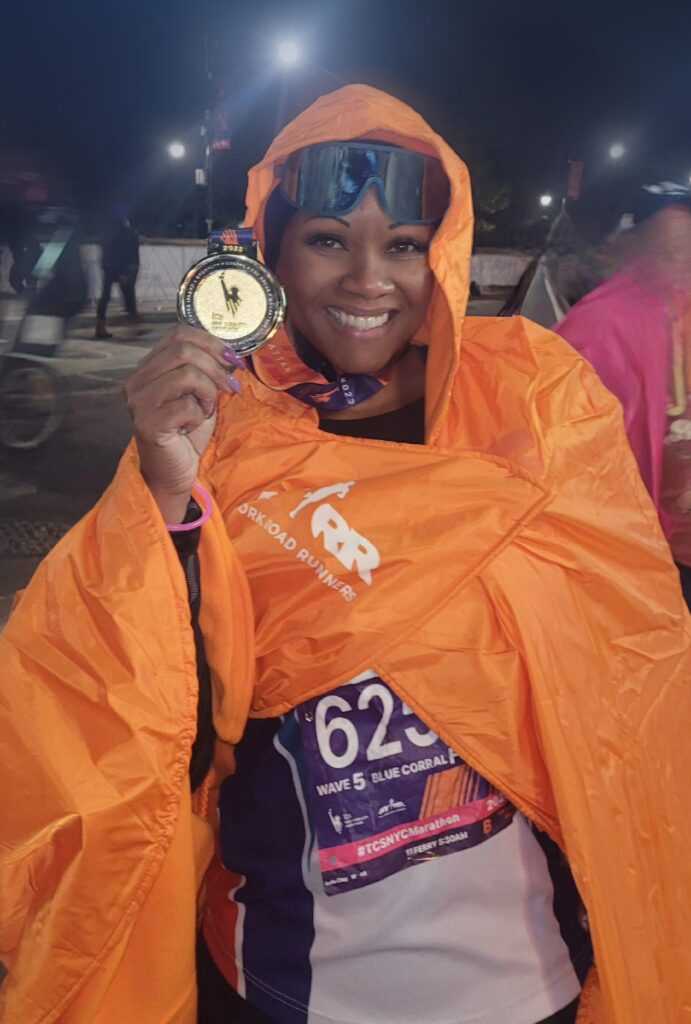 Woman holding race medal